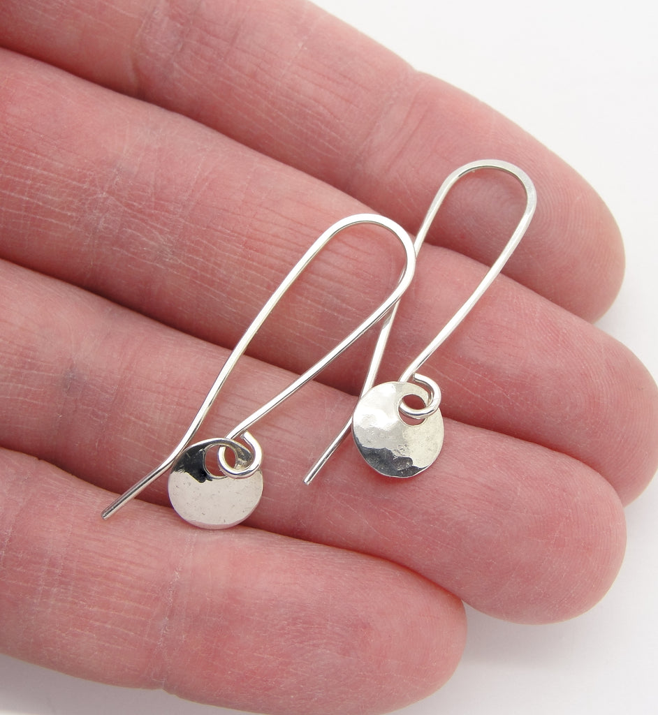 tiny sterling silver circle dot earrings in hand