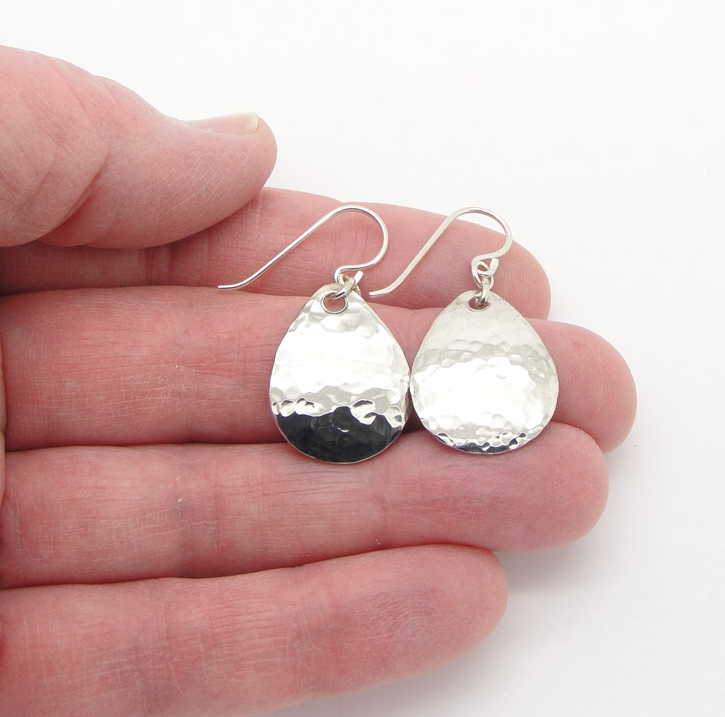 small hammered sterling silver teardrop earrings  in hand