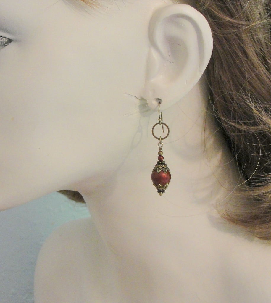 bordeaux red round manmade crystal pearl earrings with antiqued brass on model