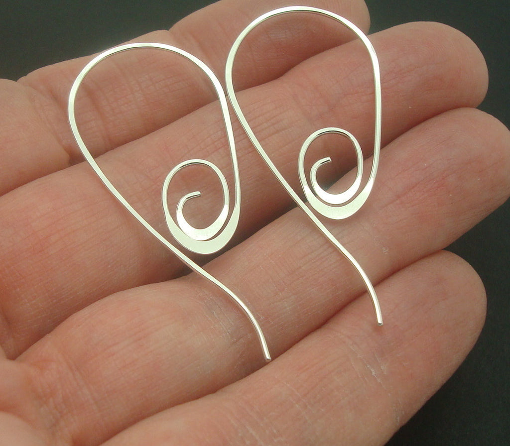 Handmade Spiral Earrings in Sterling Silver Wire in a Pull Through Style in hand