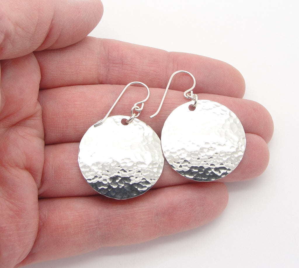 Medium 1 Inch Sterling Silver Hammered Disc Earrings  in hand